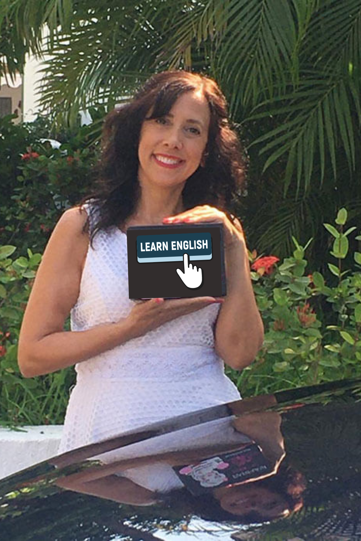 Suzanne Sanford, the CEO of Elevatest, holding up a learn English product
